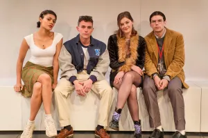 Carla Harrison-Hodge, Majid Mehdizadeh-Valoujerdy, Amber Anderson and Luke Newton are sitting in a row looking pensively during a scene in The Shape of Things at London's Park Theatre