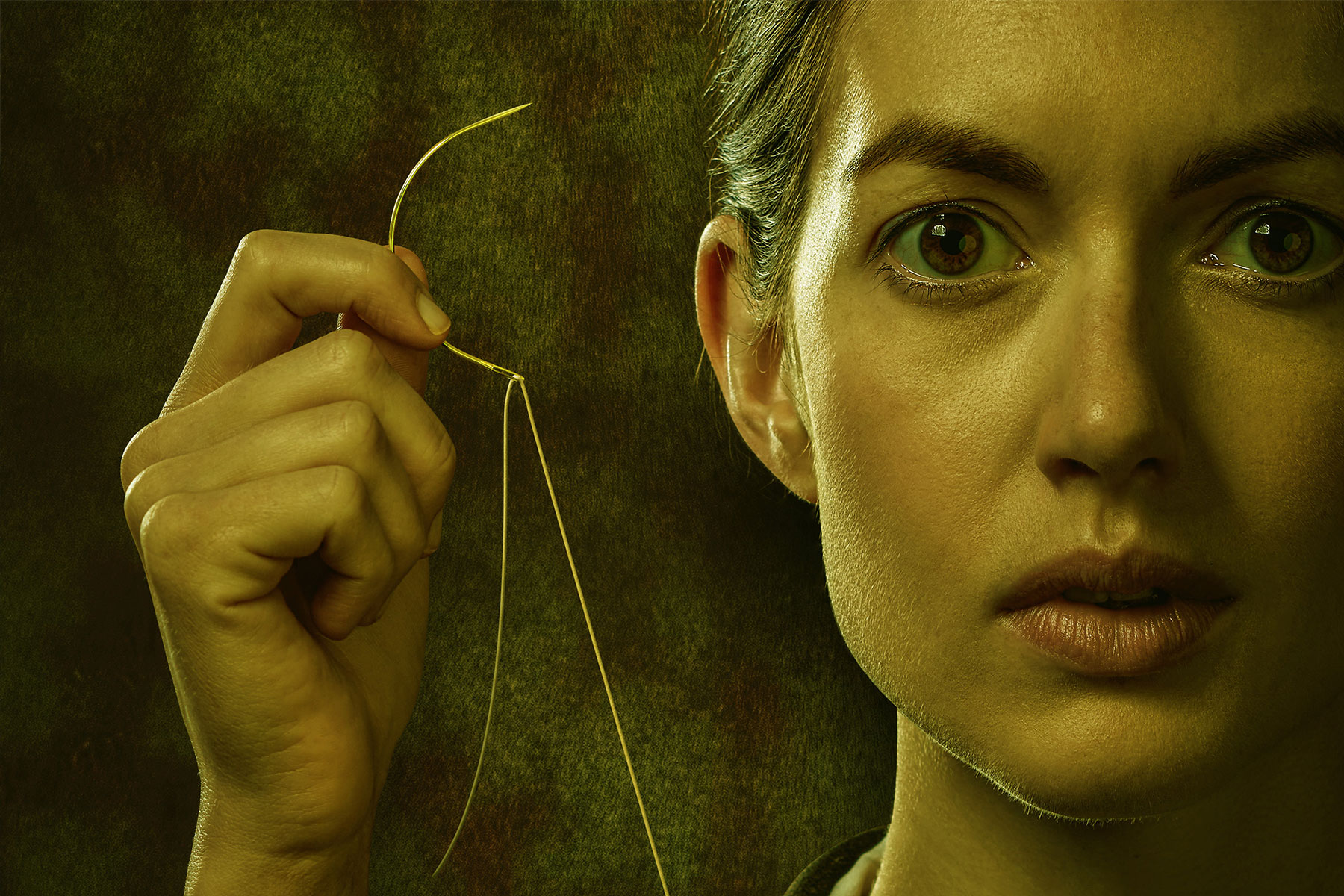 Artwork for a new adaptation of Frankenstein depicting a woman holding a needle and thread