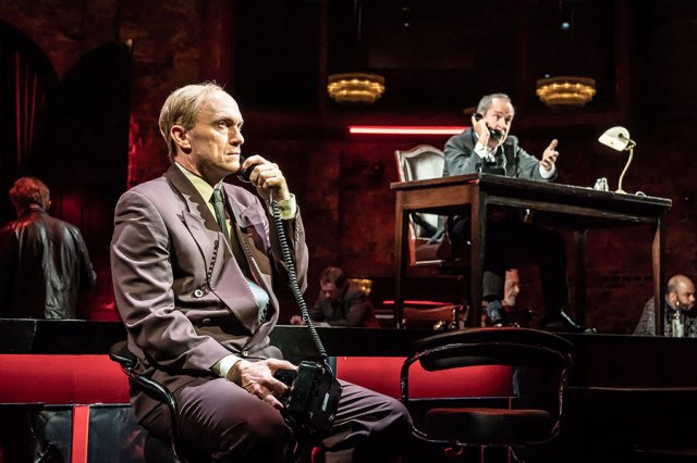 Will Keen and Tom Hollander in Patriots, holding phones to their ears