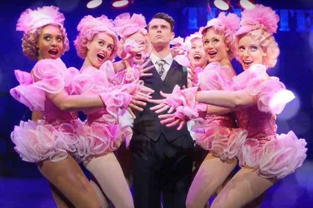 Crazy For You Thumbnail Charlie Stemp surrounded by a group of Follies dancers in a scene from Crazy for You