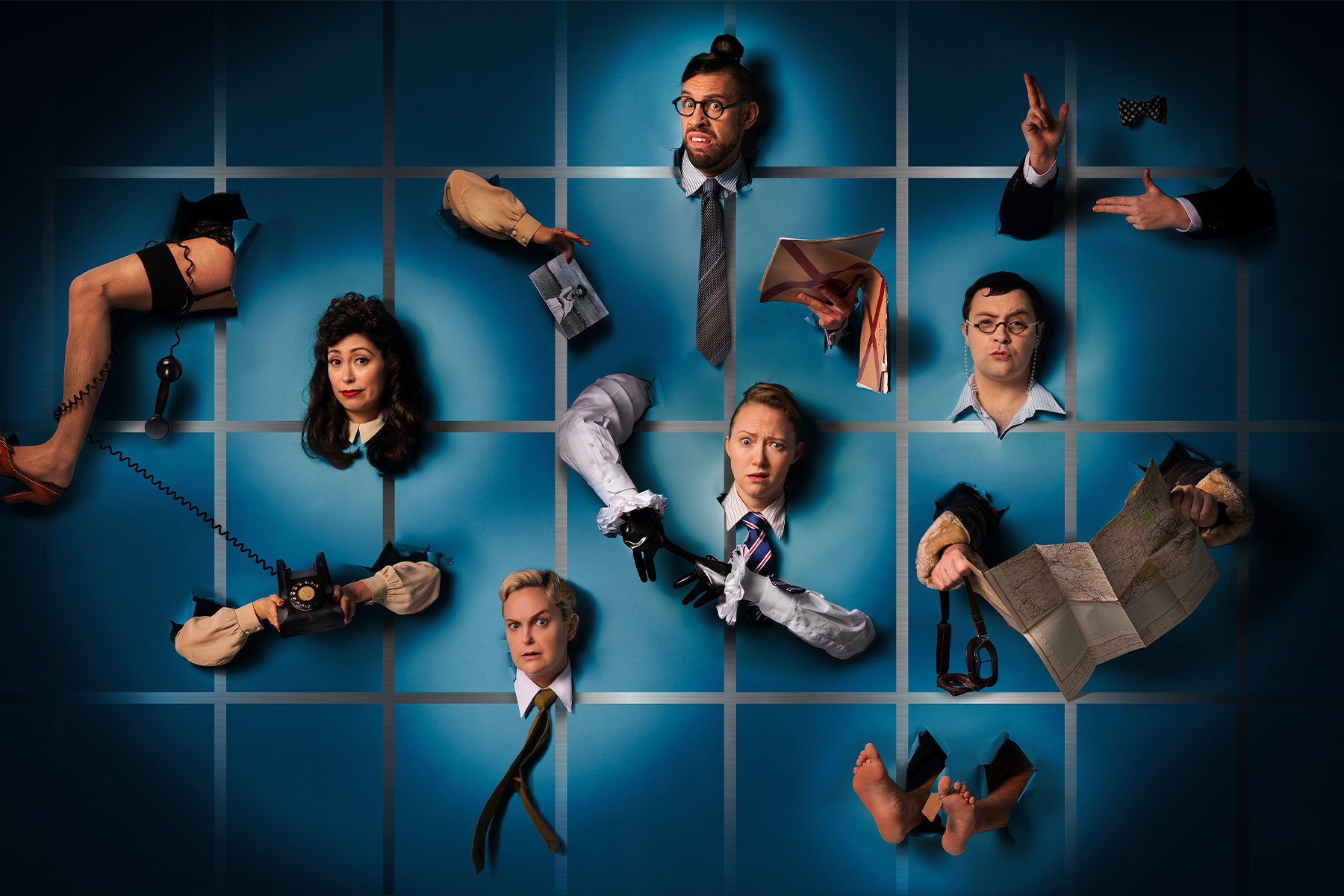 A promotional image for Operation Mincemeat depicting cast members and various limbs protruding through a wall