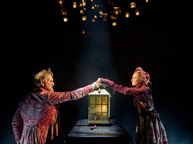 Christopher Eccleston as Ebenezer Scrooge and Rose Shalloo as Little Fan in A Christmas Carol at The Old Vic (2023), photo by Manuel Harlan