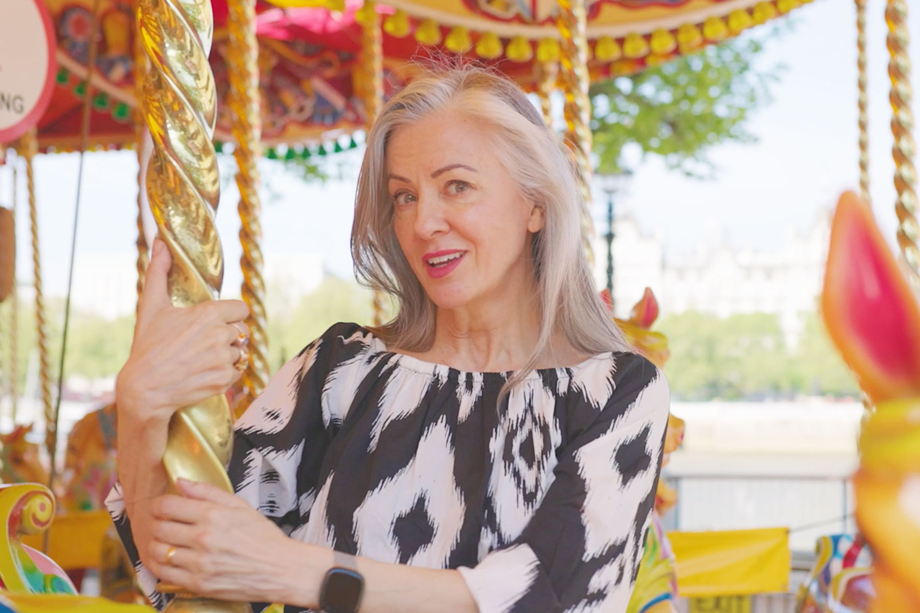 Rebecca Caine on a carousel