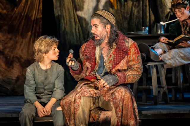Jack Philpott (as Oliver) and Simon Lipkin (as Fagin) in a scene from Oliver! at Chichester Festival Theatre