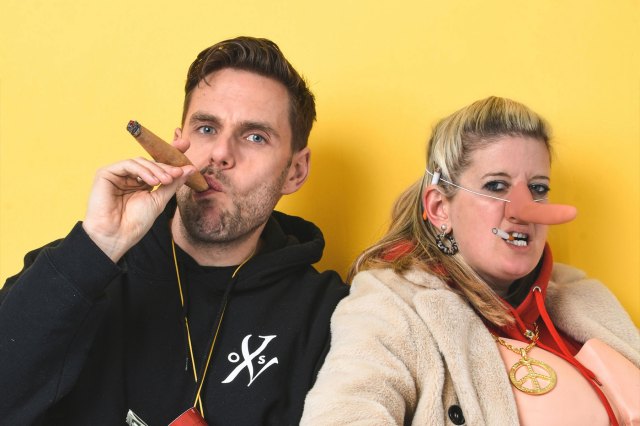 A promotional image of You Me Bum Bum Train members sporting a cigar and a long fake nose