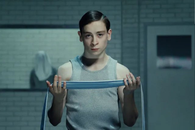 Louis McCartney (as Henry Creel) holding a blindfold in a scene from Stranger Things: The First Shadow