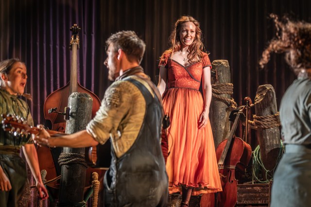 Clare Foster as Elowen Keene in a red dress