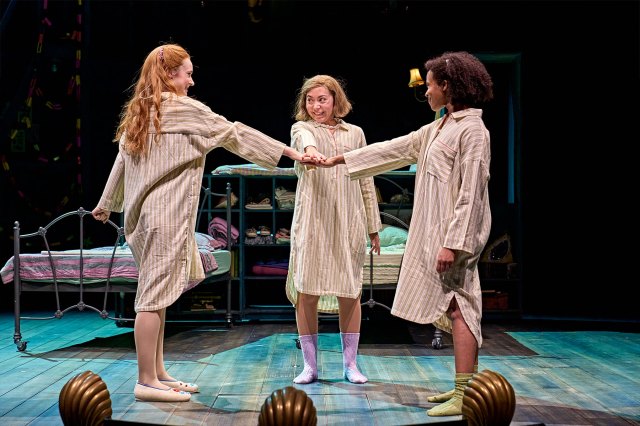 Three young actresses in nightdresses on stage