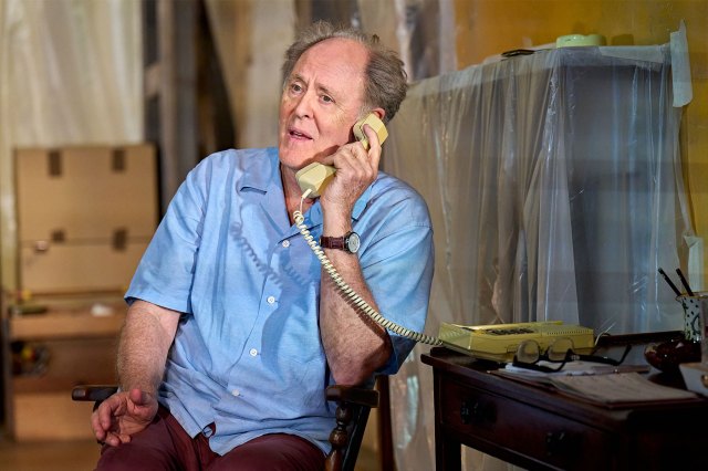 John Lithgow in Giant A seated actor is on the telephone on stage