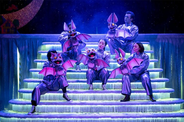 Five actors on stage holding cartoonish bat puppets