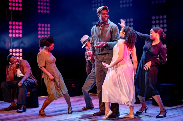 A group of actors dancing on stage