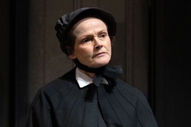 An actress on stage in a period nun costume