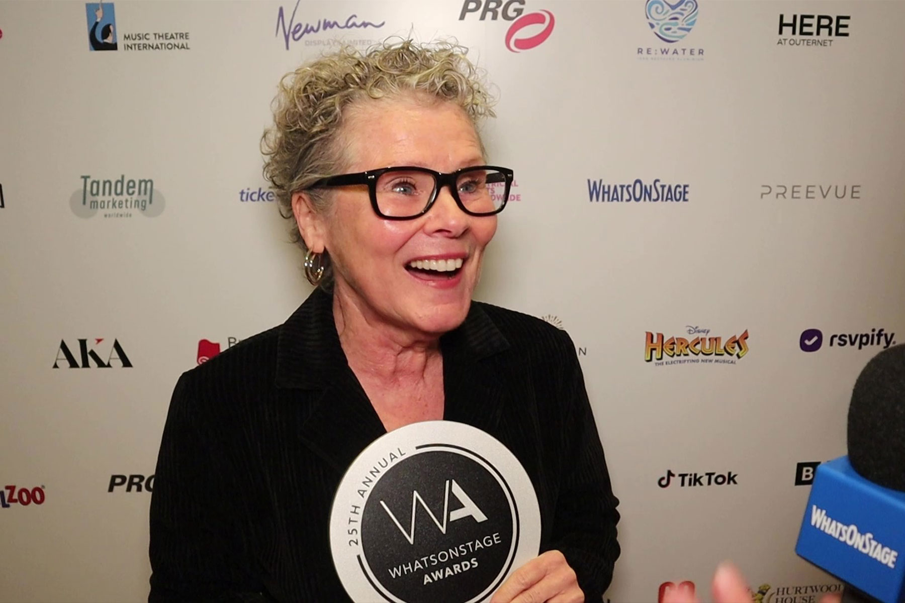 Actor Imelda Staunton holding a WhatsOnStage Award trophy