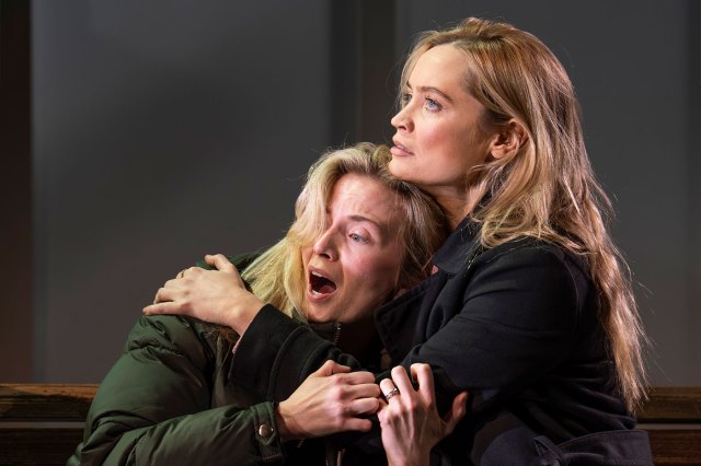 An actress consoles another actress on stage