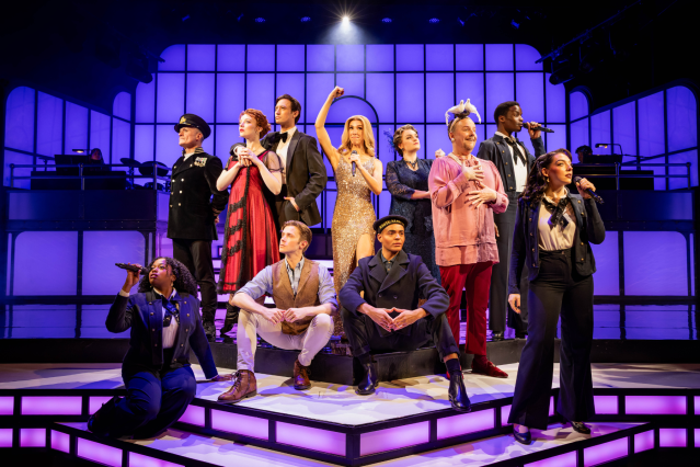 The West End cast of Titanique pose on stage