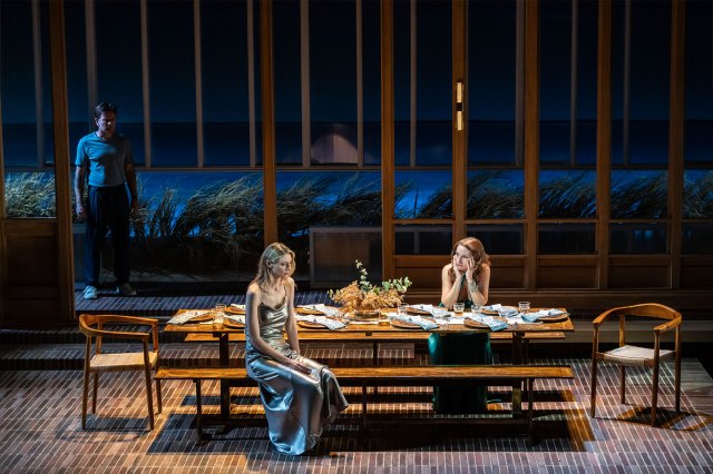 Three actors on stage on a modern dining room set