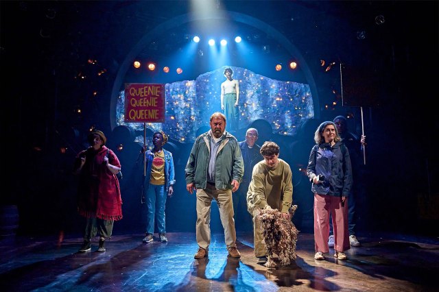 A group of actors gathered together on stage.