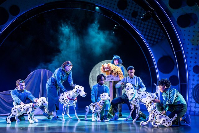 A group of actors and dalmatian puppets on stage
