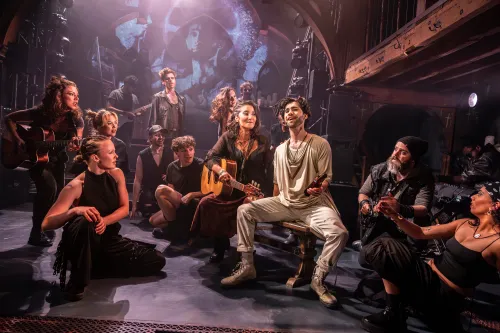 A group of actor-musicians gathered on stage