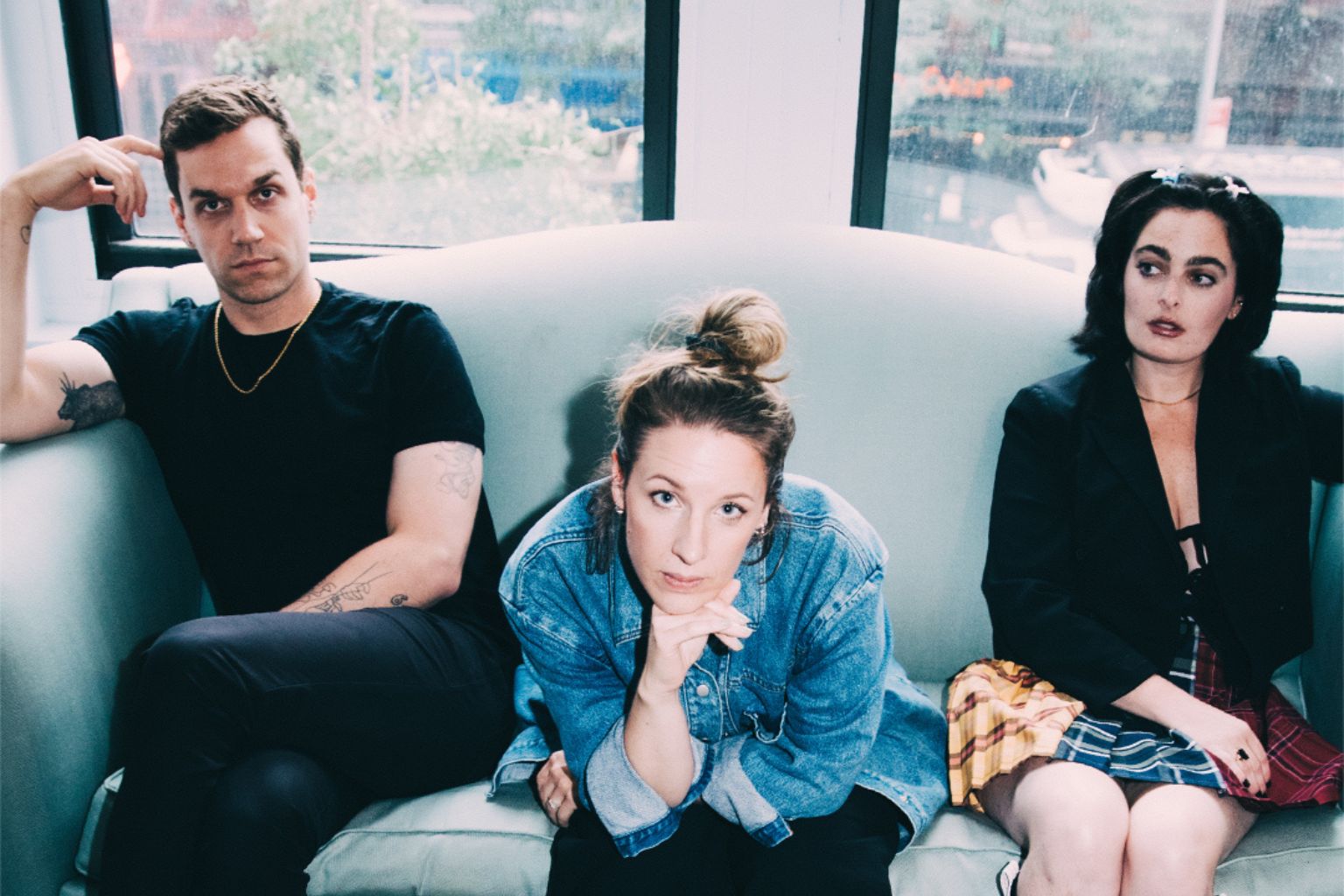 Beautiful Little Fool artwork shows three performers looking fed up sat awkwardly on a sofa