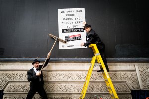 The stars of The Producers get to work putting up the show’s signage